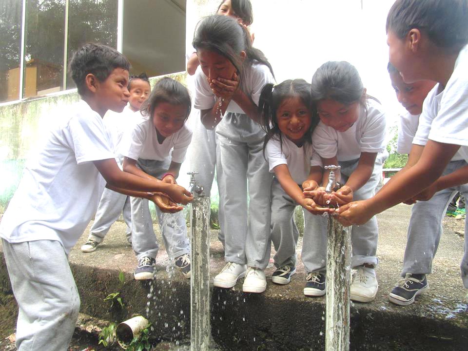 En la foto se ve a un grupo de niños de la población kichwa tomando agua.
